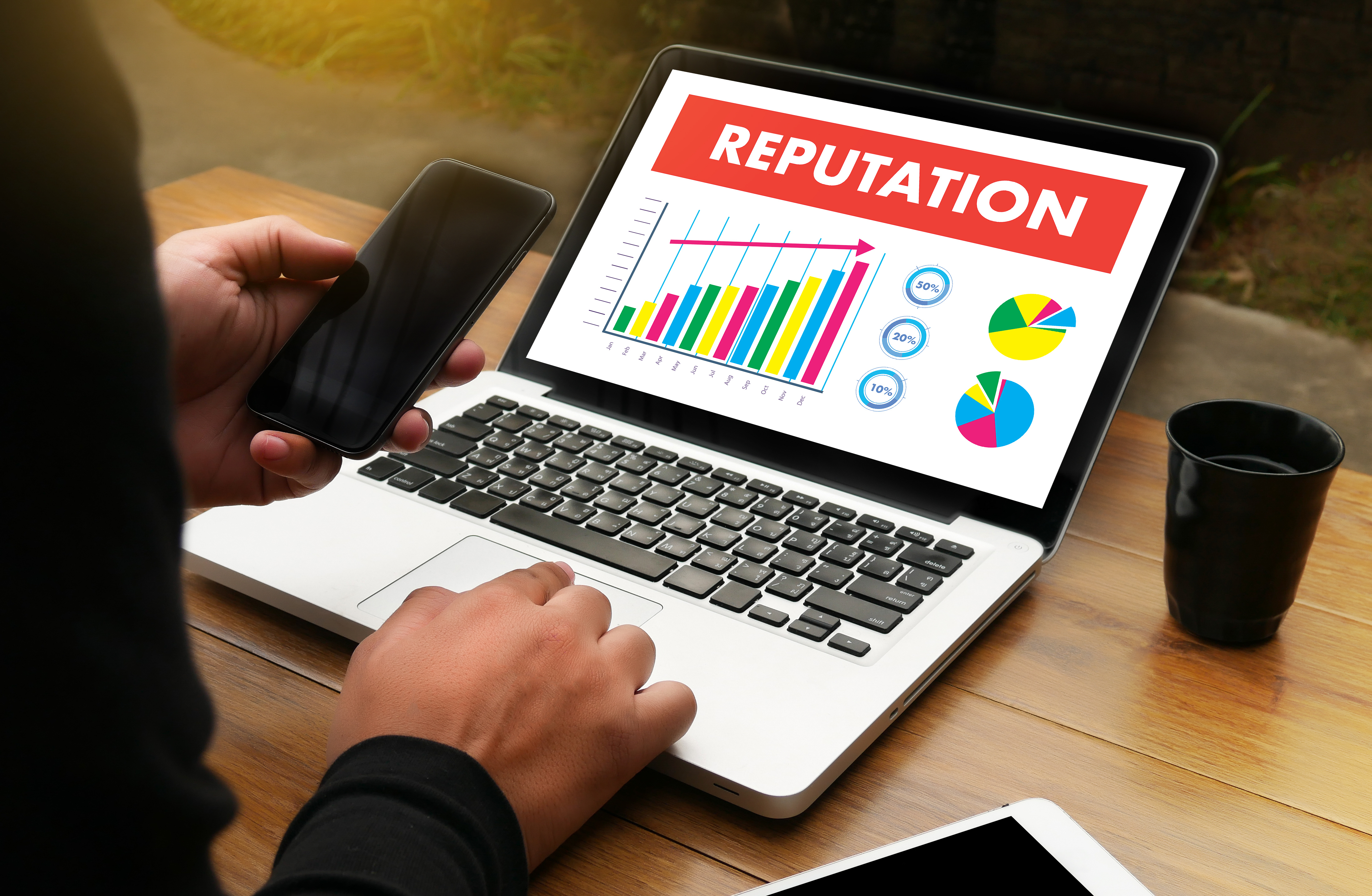 Person at laptop viewing a graph displaying improvements in their reputation.